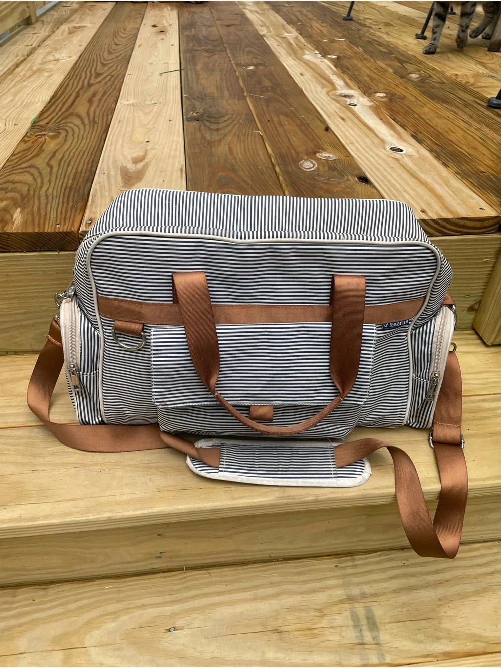 O' Beanie White and Navy Striped Diaper Bag. Brown straps with shoulder pad.